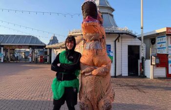 Two students from Sussex Men's Rugby Club pose in fancy dress by Brighton Palace Pier, as part of a charity fun run.