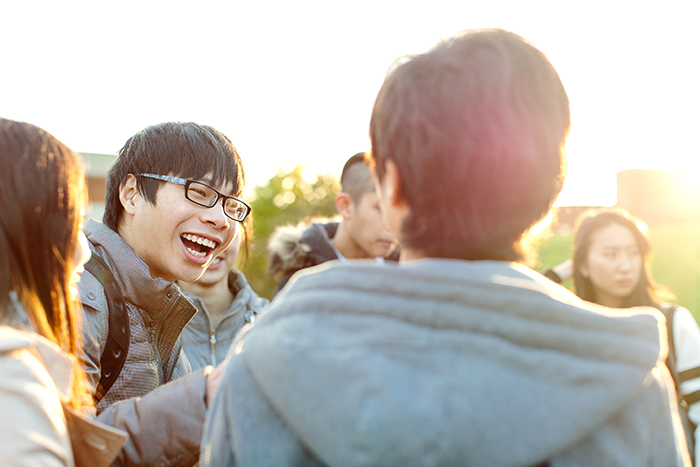 International students sit at a table talking at a cafe at the University of Sussex