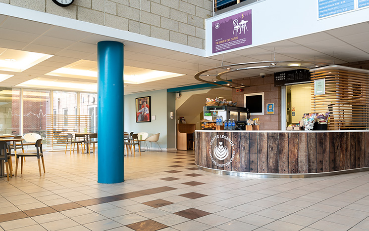 Spacious cafe with the counter and some parts of the seating area showing.